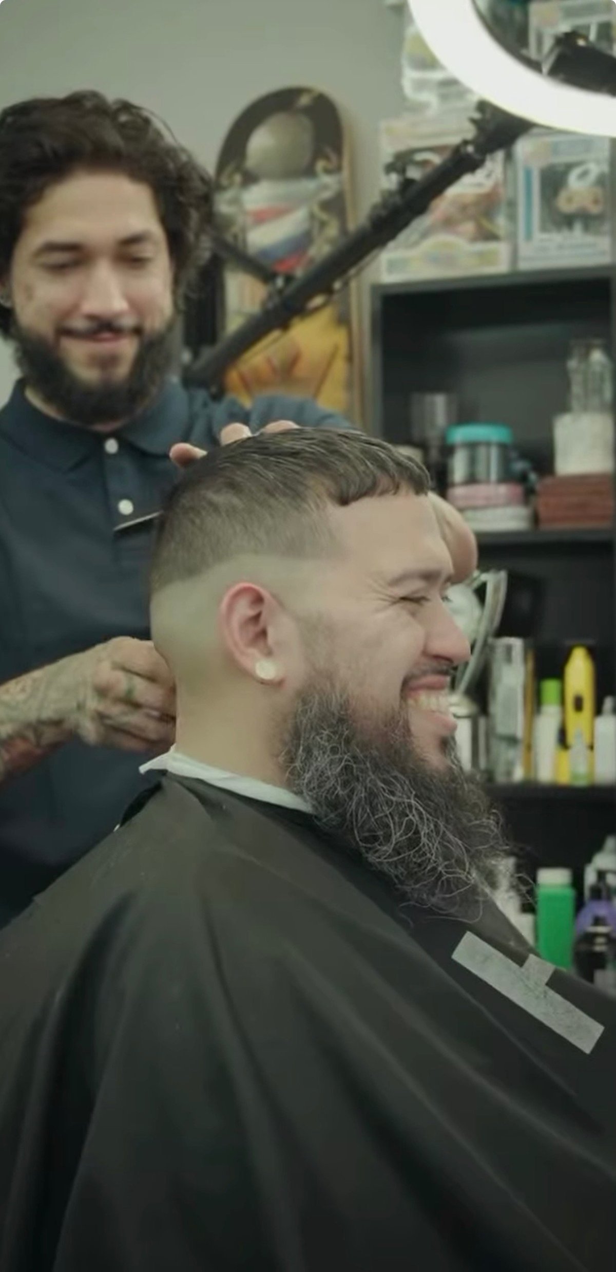 Studio Blends client laughing after a fresh fade and beard trim